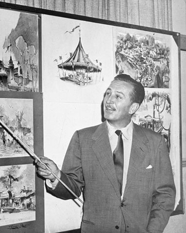 photo of Walt Disney pointing to artist renderings of Disneyland
